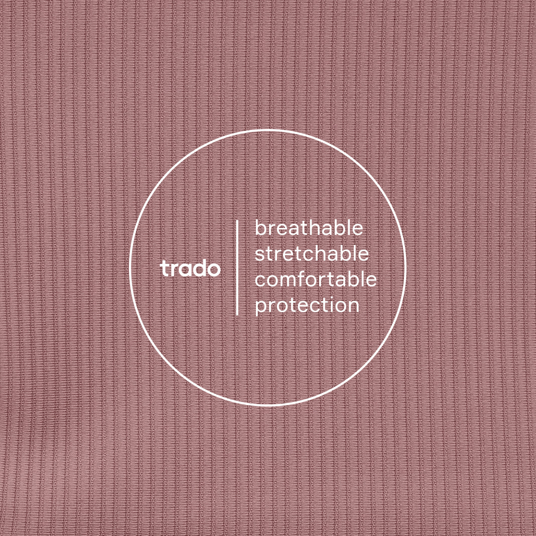 Text 'trado' with descriptors 'breathable', 'stretchable', 'comfortable', 'protection' on a dusty rose textured background